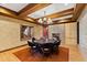 Elegant dining room with exposed wood beams, brick accent wall and views to the exterior at 6532 Wakefalls Dr, Wake Forest, NC 27587