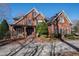 Charming brick home featuring well-maintained landscaping, classic shutters, and a welcoming covered porch at 6532 Wakefalls Dr, Wake Forest, NC 27587