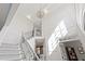 Bright foyer boasts a grand staircase with iron railings, wainscoting, and a chandelier at 6532 Wakefalls Dr, Wake Forest, NC 27587