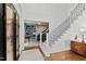 Grand foyer featuring a staircase with iron railings, hardwood floors, and elegant wainscoting at 6532 Wakefalls Dr, Wake Forest, NC 27587