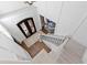 A view from above captures the grand foyer with detailed staircase, iron doors, and rich hardwood floors at 6532 Wakefalls Dr, Wake Forest, NC 27587