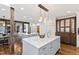 Open kitchen with double islands, marble countertops, pendant lighting and wood floors at 6532 Wakefalls Dr, Wake Forest, NC 27587