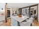 Spacious kitchen island with seating, marble countertop, and views of the breakfast area and living room at 6532 Wakefalls Dr, Wake Forest, NC 27587