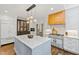 A well appointed kitchen with marble island, stainless steel appliances, and custom wood cabinets at 6532 Wakefalls Dr, Wake Forest, NC 27587