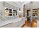Bright kitchen features a farmhouse sink, marble countertops and decorative tile backsplash under a large window at 6532 Wakefalls Dr, Wake Forest, NC 27587