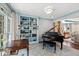 Sophisticated living room showcases a grand piano, custom built-ins, and elegant decor at 6532 Wakefalls Dr, Wake Forest, NC 27587