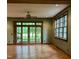 Living room with wood floors, green walls, french doors and a large window at 6532 Wakefalls Dr, Wake Forest, NC 27587