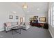 Bright living room with vaulted ceilings, stylish black and white carpet and built-in desk and shelves at 6532 Wakefalls Dr, Wake Forest, NC 27587