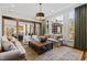 Inviting living room with large windows, comfortable seating, and open access to the kitchen and dining area at 6532 Wakefalls Dr, Wake Forest, NC 27587