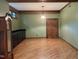 Living room boasts wood floors, wood beams, green walls, and wooden door at 6532 Wakefalls Dr, Wake Forest, NC 27587