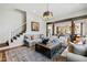 Cozy living room with neutral decor, a stylish chandelier, and open layout to the kitchen at 6532 Wakefalls Dr, Wake Forest, NC 27587