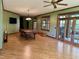 Spacious living room featuring wood floors, an ornate pool table, and double doors to the outside patio at 6532 Wakefalls Dr, Wake Forest, NC 27587