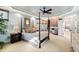Spacious main bedroom featuring a sitting area, four poster bed, and ample natural light at 6532 Wakefalls Dr, Wake Forest, NC 27587