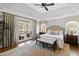 Light-filled main bedroom boasts trey ceiling, hardwood floors, balcony access, and a seating bench at 6532 Wakefalls Dr, Wake Forest, NC 27587