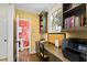 This office features hardwood floors, built-in bookshelves, and a nearby powder room with floral wallpaper at 6532 Wakefalls Dr, Wake Forest, NC 27587