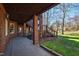 Outdoor covered patio with brick columns, wooden stairs, stamped concrete floor, and lawn at 6532 Wakefalls Dr, Wake Forest, NC 27587