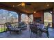 Inviting covered patio with brick fireplace, ceiling fans, and comfortable seating and dining areas at 6532 Wakefalls Dr, Wake Forest, NC 27587