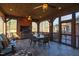 Cozy covered patio featuring a brick fireplace, ceiling fans, and a dining set for outdoor entertaining at 6532 Wakefalls Dr, Wake Forest, NC 27587