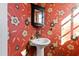 This powder room features unique floral wallpaper and a pedestal sink at 6532 Wakefalls Dr, Wake Forest, NC 27587