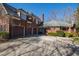Expansive brick home showcasing a three-car garage, spacious driveway, and a basketball hoop at 6532 Wakefalls Dr, Wake Forest, NC 27587