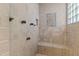 Tiled shower features multiple shower heads and a built-in bench at 6532 Wakefalls Dr, Wake Forest, NC 27587