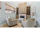 Sitting area with a fireplace, built in shelves, two chairs, and ample natural light at 6532 Wakefalls Dr, Wake Forest, NC 27587