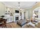 Bright sitting room showcases a fireplace, built-in shelving, and comfortable seating at 6532 Wakefalls Dr, Wake Forest, NC 27587