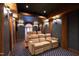 This home theater room features tiered seating, a projector, wooden beams, and sconce lighting at 6532 Wakefalls Dr, Wake Forest, NC 27587