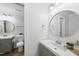 Bright bathroom with dual sinks, round mirrors, and modern fixtures at 689 Pine Ridge Pl, Raleigh, NC 27609