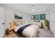 Cozy bedroom featuring wood floors, a dresser, and a large window offering natural light at 689 Pine Ridge Pl, Raleigh, NC 27609