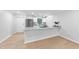 Well-lit kitchen featuring white cabinets, a breakfast bar, and stainless steel appliances at 689 Pine Ridge Pl, Raleigh, NC 27609