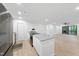 Modern kitchen with an island, stainless steel appliances, and an open layout to the living area at 689 Pine Ridge Pl, Raleigh, NC 27609