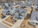 Aerial view of a two-story home featuring a landscaped yard, driveway, and a two-car garage at 730 Tibumoll Ln, Fuquay Varina, NC 27526