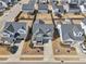 Aerial view of neighborhood featuring two-story homes, manicured lawns, and paved roads, showcasing community layout at 730 Tibumoll Ln, Fuquay Varina, NC 27526
