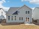 Back of gray home featuring a fenced yard, patio, and lots of windows at 730 Tibumoll Ln, Fuquay Varina, NC 27526
