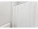Clean bathroom featuring a toilet, a shower with a white curtain, and neutral tones at 730 Tibumoll Ln, Fuquay Varina, NC 27526