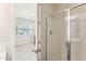 Clean bathroom with modern glass shower enclosure and an open door to the bedroom at 730 Tibumoll Ln, Fuquay Varina, NC 27526