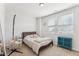 Bright bedroom featuring a comfortable bed, a hanging chair, and a colorful cabinet at 730 Tibumoll Ln, Fuquay Varina, NC 27526
