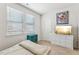 Sunlit bedroom features two large windows, a modern dresser, and tasteful decor at 730 Tibumoll Ln, Fuquay Varina, NC 27526