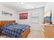 Cozy bedroom with a wooden bed frame, plaid bedding, and a TV for relaxation at 730 Tibumoll Ln, Fuquay Varina, NC 27526