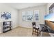 Well-lit bedroom with a desk, chair, and a shelf for storage at 730 Tibumoll Ln, Fuquay Varina, NC 27526