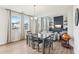 Inviting dining area with modern table set, abundant natural light, and seamless flow to the living area at 730 Tibumoll Ln, Fuquay Varina, NC 27526