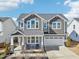 Beautiful two-story home featuring a covered front porch, manicured landscaping, and a two-car garage at 730 Tibumoll Ln, Fuquay Varina, NC 27526