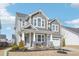 Charming two-story home with a covered front porch, detailed columns, and a two-car garage at 730 Tibumoll Ln, Fuquay Varina, NC 27526
