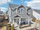 Two-story home featuring an inviting covered front porch, stone columns, and a two-car garage at 730 Tibumoll Ln, Fuquay Varina, NC 27526
