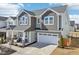 Charming two-story home featuring a covered front porch, stone accents, and a convenient two-car garage at 730 Tibumoll Ln, Fuquay Varina, NC 27526