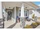 Welcoming front porch with stone pillars, seating, and stylish front door at 730 Tibumoll Ln, Fuquay Varina, NC 27526