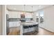 Modern kitchen with stainless steel appliances, granite countertops, and sleek white cabinets at 730 Tibumoll Ln, Fuquay Varina, NC 27526