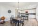 Open concept kitchen and dining area featuring a large island, dining table, and modern lighting at 730 Tibumoll Ln, Fuquay Varina, NC 27526