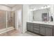 Elegant main bathroom with double vanity, walk-in shower, and neutral color palette at 730 Tibumoll Ln, Fuquay Varina, NC 27526